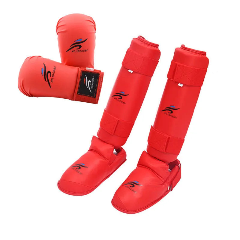 Red karate taekwondo protective gear set with leg guard, helmet and boxing gloves on white background