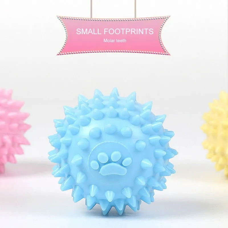 Blue TPR dog chewing ball with footprint design and bulging sides for tooth cleaning.