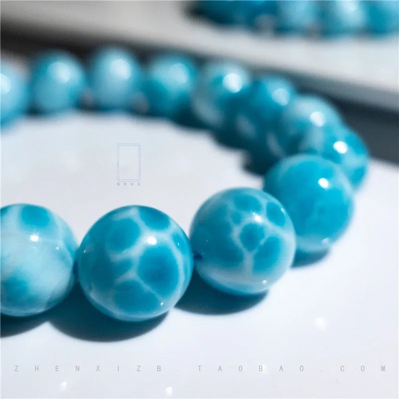 Blue handmade Bodhi bead bracelet with crystal sea-pattern stone and pearl accent on wrist