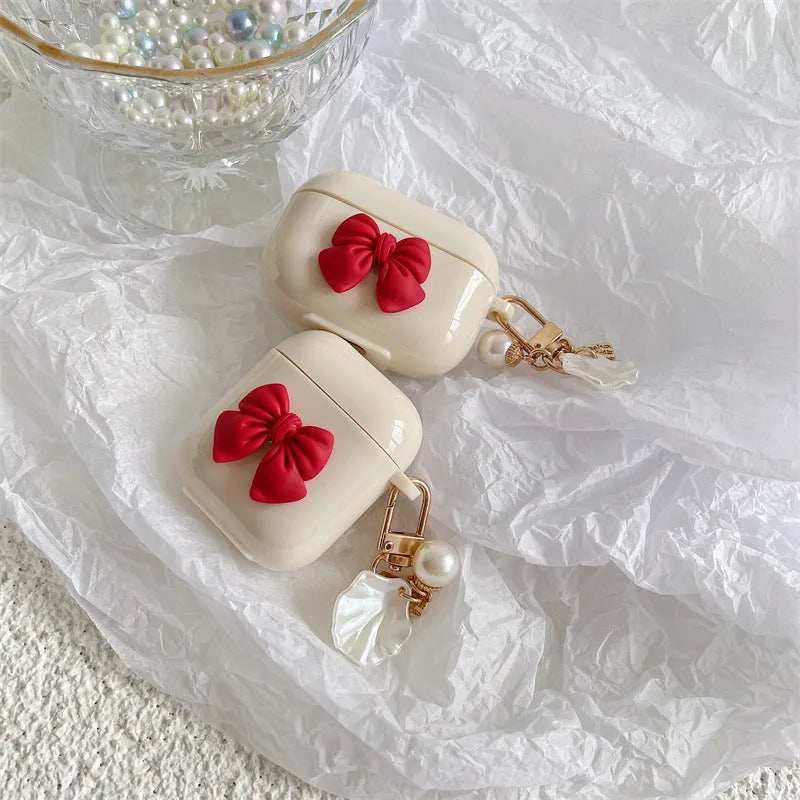Beige red bow shell coloured TPU clamshell case cover for Apple AirPods charging case.