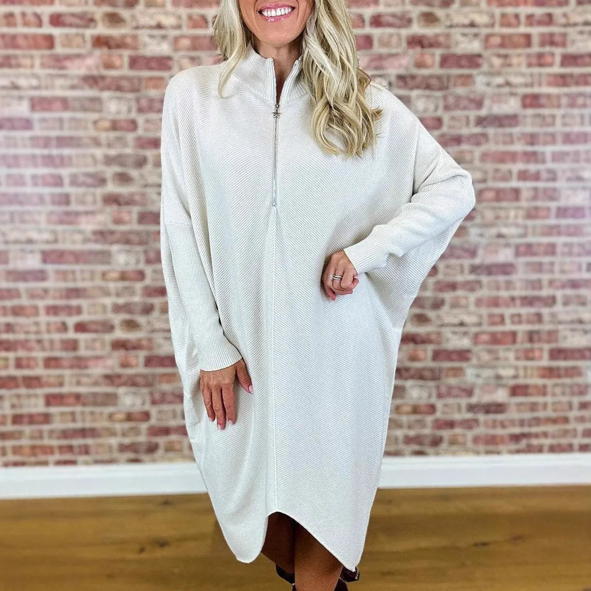 Women's solid colour loose knitted dress with raglan sleeves and a front zipper.
