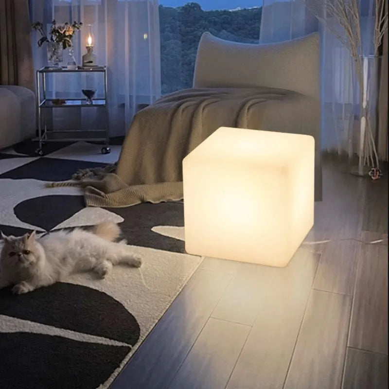 White square LED cube garden light stool with modern design, shown outdoors.