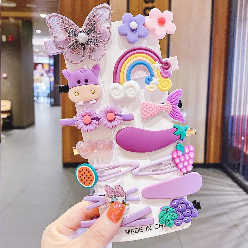 14-piece set of colourful toddler hair clips with candy, fruit, rainbow, and butterfly designs on a white background.