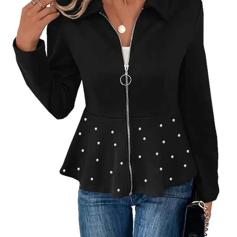 Women's black loose-fit coat with heavy-duty front zipper and ruffle hem detail.