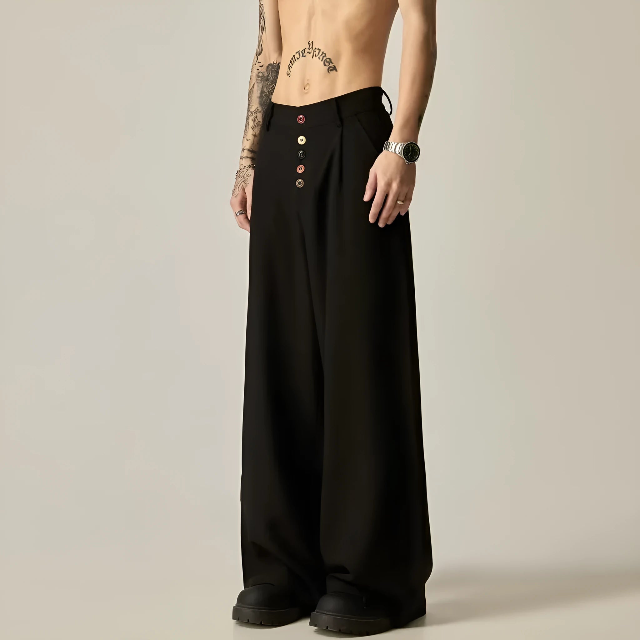 Man wearing black solid colour wide-leg casual trousers with a vertical tube design.