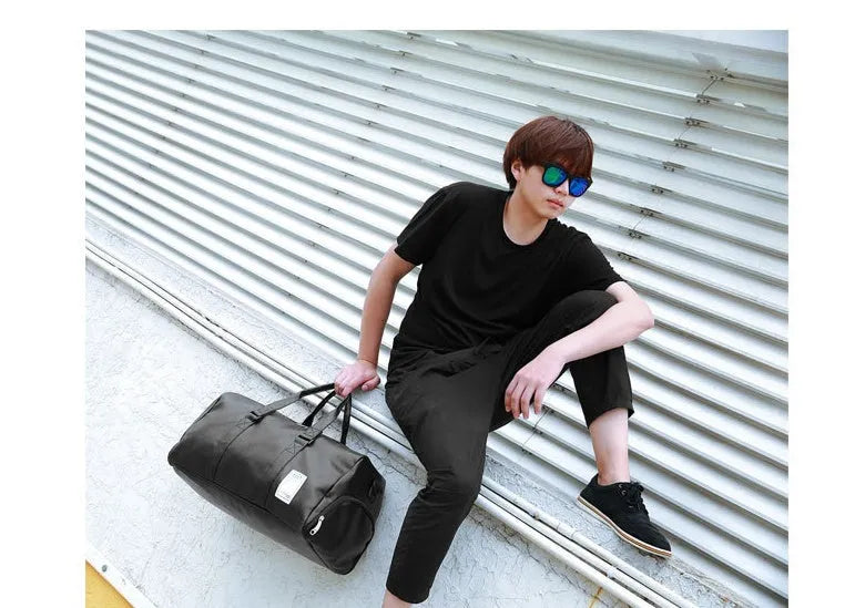 Black waterproof sports bag with separate side shoe compartments and a diagonal shoulder strap