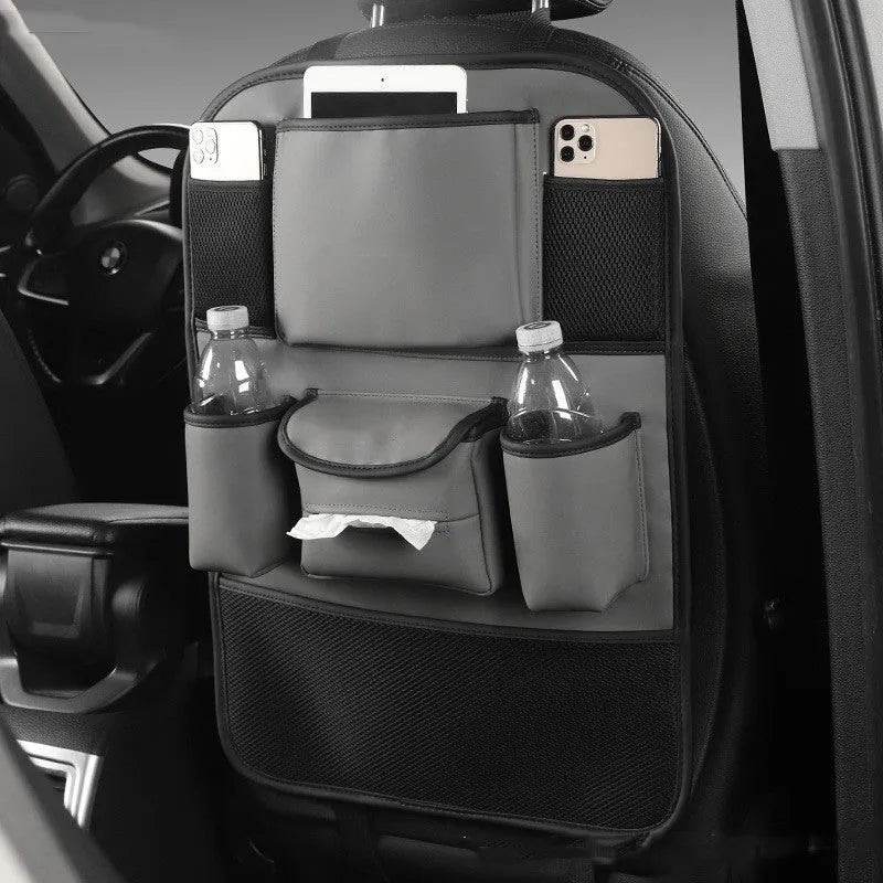 Black leather storage bag hanging on the back of a car seat.