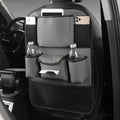Black leather storage bag hanging on the back of a car seat.