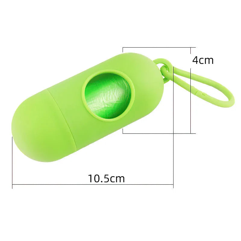 A small, square black plastic dog poop bag holder with a metal hook and Velcro strap.