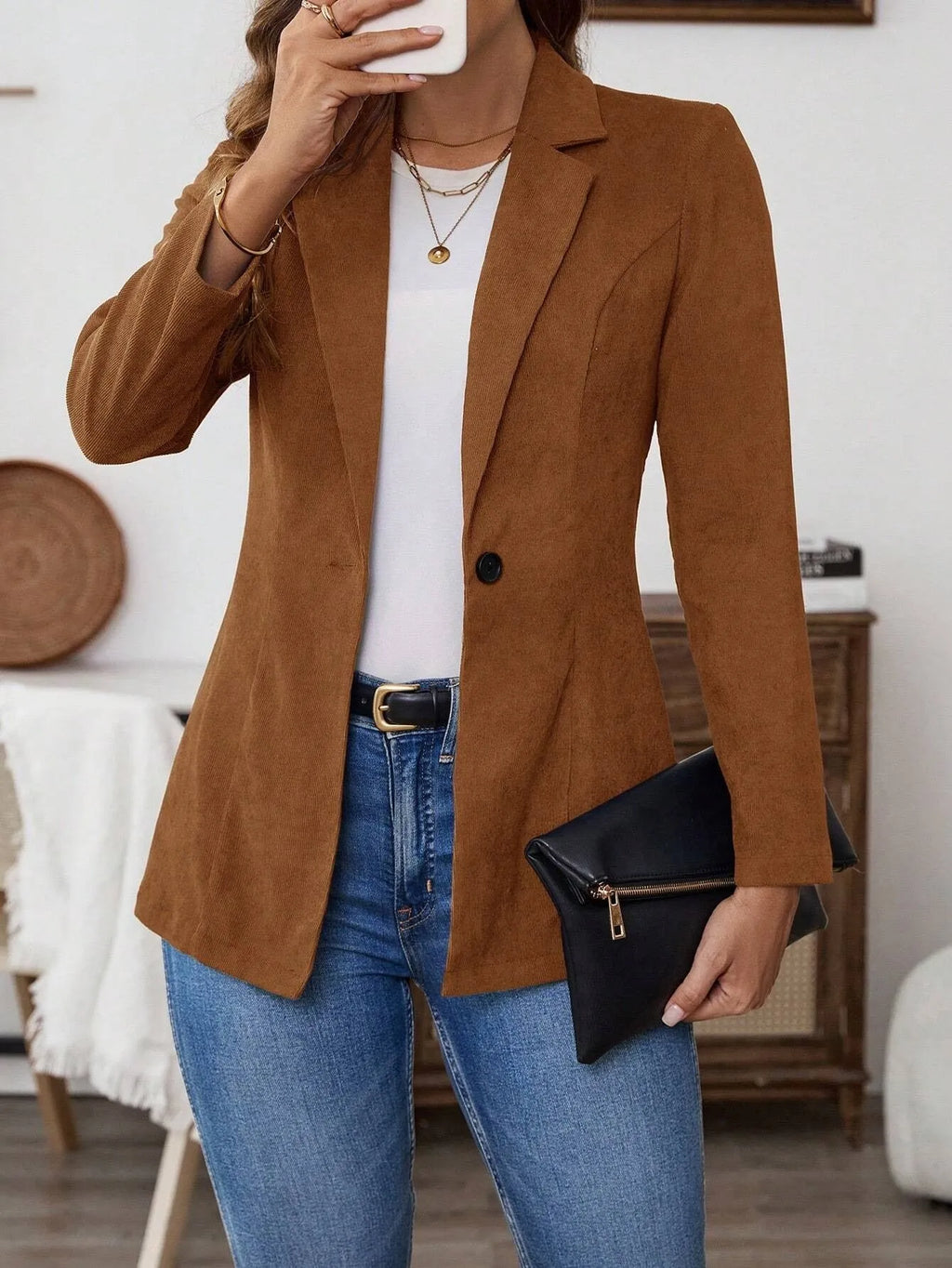 Brown men's single-breasted lapel coat with long sleeves on a hanger