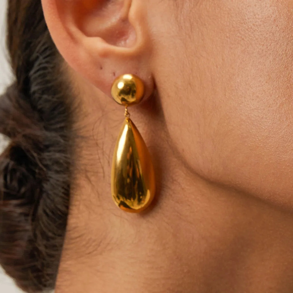 Gold electroplated stainless steel earrings with geometric hemisphere and water droplet pendant design