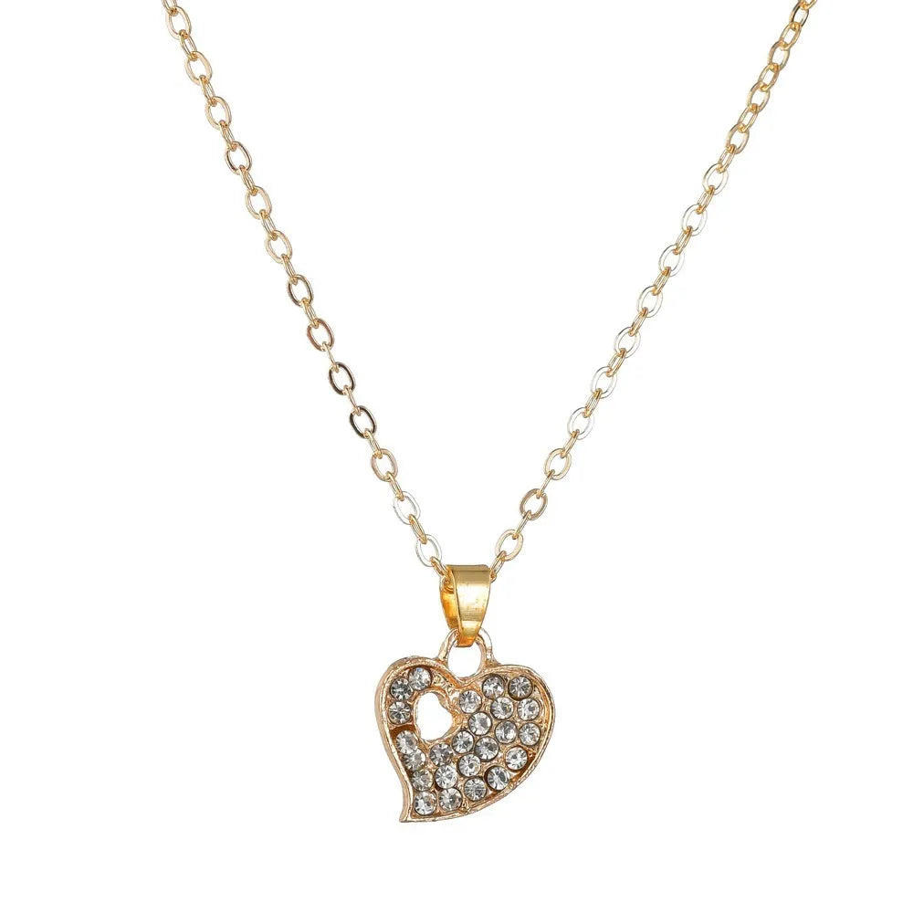 Gold women's jewellery set featuring earrings, an adjustable necklace, and a bracelet with heart, water drop, and bell pendants.