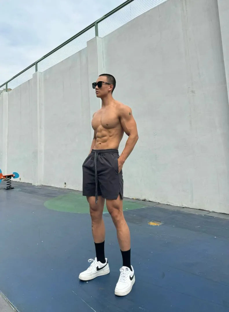 Men's ice silk quick-drying shorts in light grey on a hanger