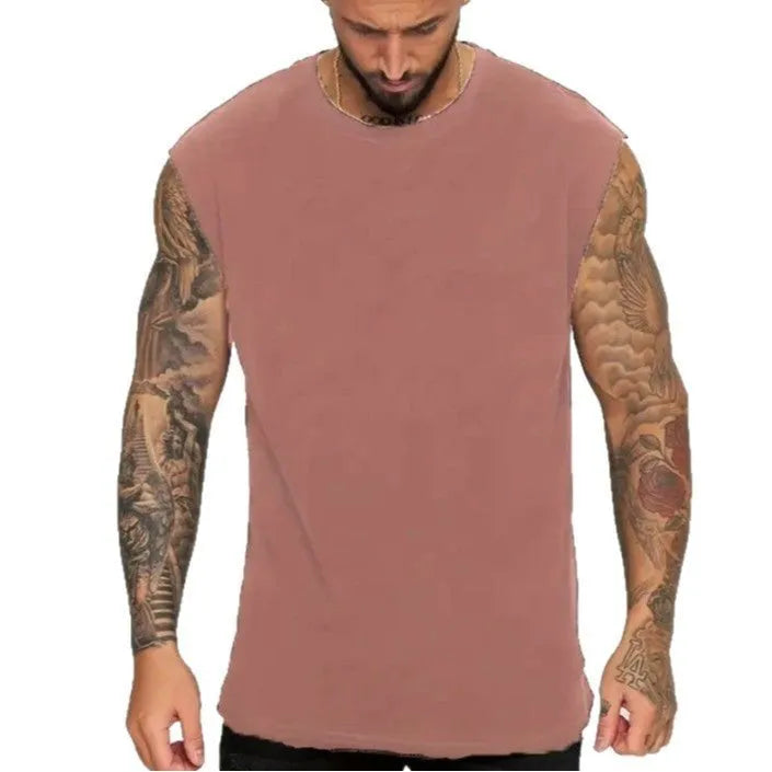 Men's solid colour loose sleeveless cotton tank top on a hanger, shown in apricot colour.