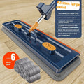 Large flat mop with stainless steel handle and 360-degree rotating head on hard floor