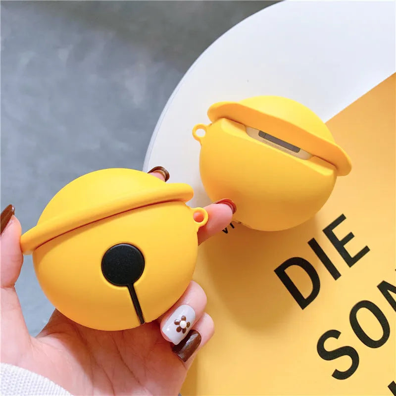 Yellow silicone protective case for AirPods with a small bell charm and a carry strap.