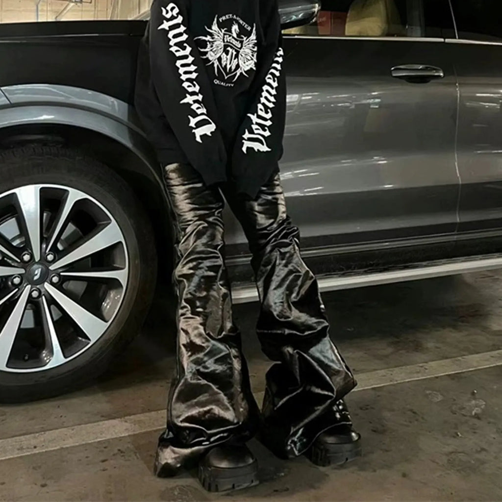 Black coated shiny patent leather skinny jeans in a straight-leg style on a mid waist.