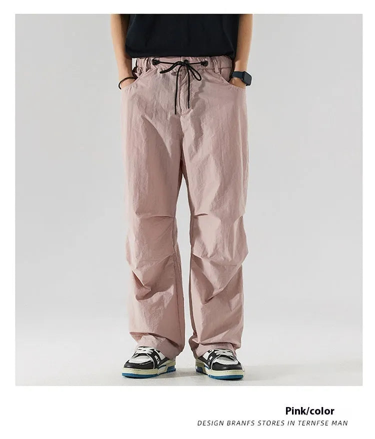 Men's thin ice silk nylon trousers in a loose straight leg fit, shown in apricot colour