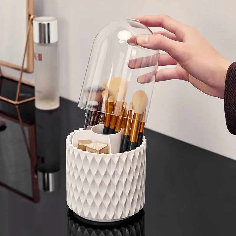 White acrylic rotating makeup brush holder with transparent dust cover on desktop