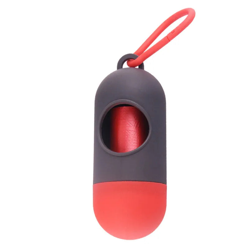 A small, square black plastic dog poop bag holder with a metal hook and Velcro strap.
