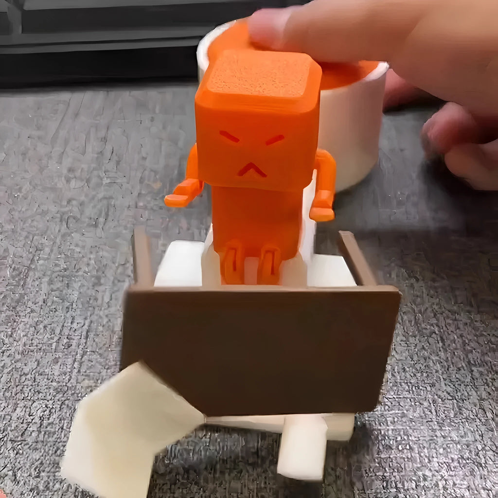 Orange plastic table turning decompression toy artefact on a flat surface.