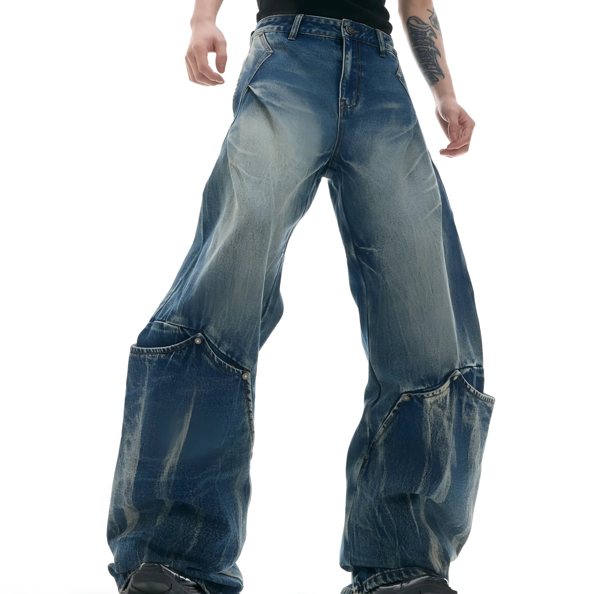 Men's verdant blue loose fit jeans with a retro washed burst pattern and curved knife design details.