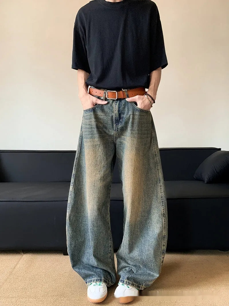 Retro blue distressed machete denim jeans for men with a wide-leg slim cut.