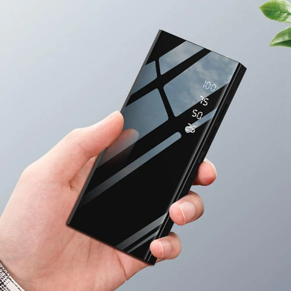 Black 20000mAh power bank with LCD percentage display showing dual USB output ports