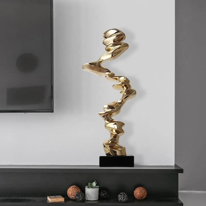 Modern abstract still life sculpture ornament in natural resin on a wooden table.