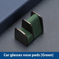 Zinc alloy and leather car dashboard clip for holding sunglasses, shown in green colour.