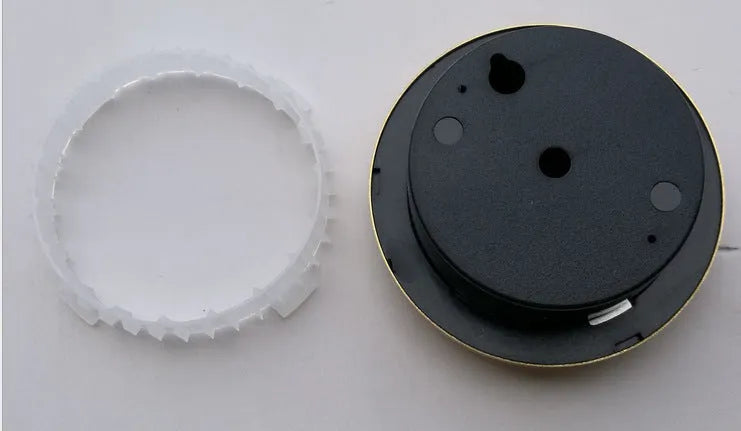 Analogue thermometer and hygrometer with silver aluminium outer ring and dial showing temperature and humidity scales.