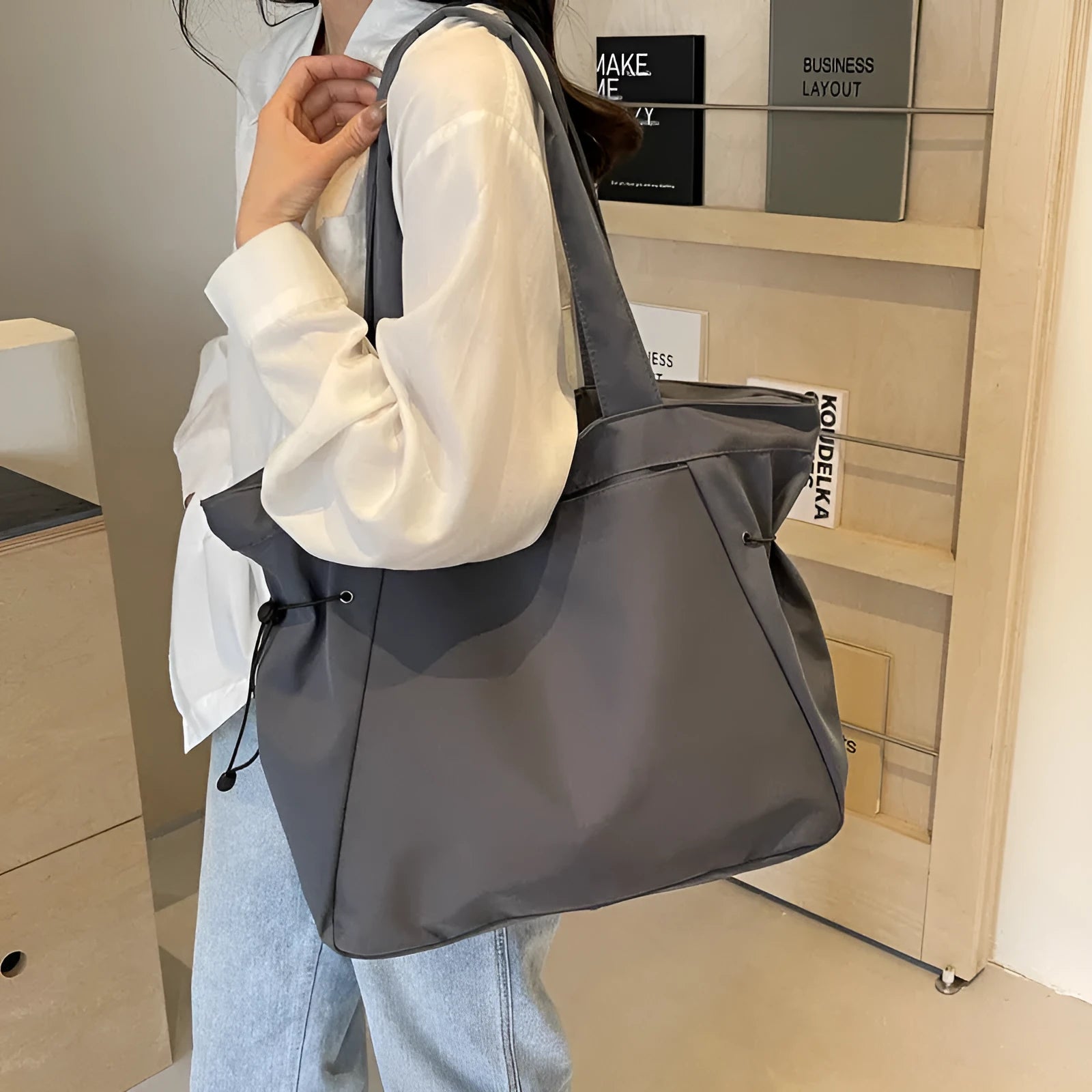 Oxford cloth shoulder tote bag in folding design showing soft construction and shoulder strap