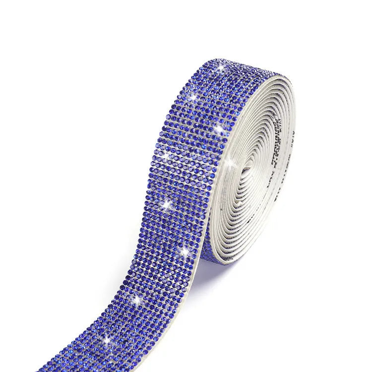 Self-adhesive water drill strip for clothing decoration in white and AB colour on a fabric background.