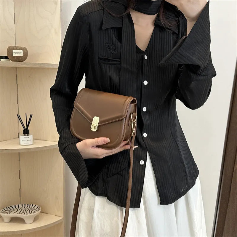 Soft PU leather messenger bag with clamshell opening shown in horizontal square shape on a shoulder strap.