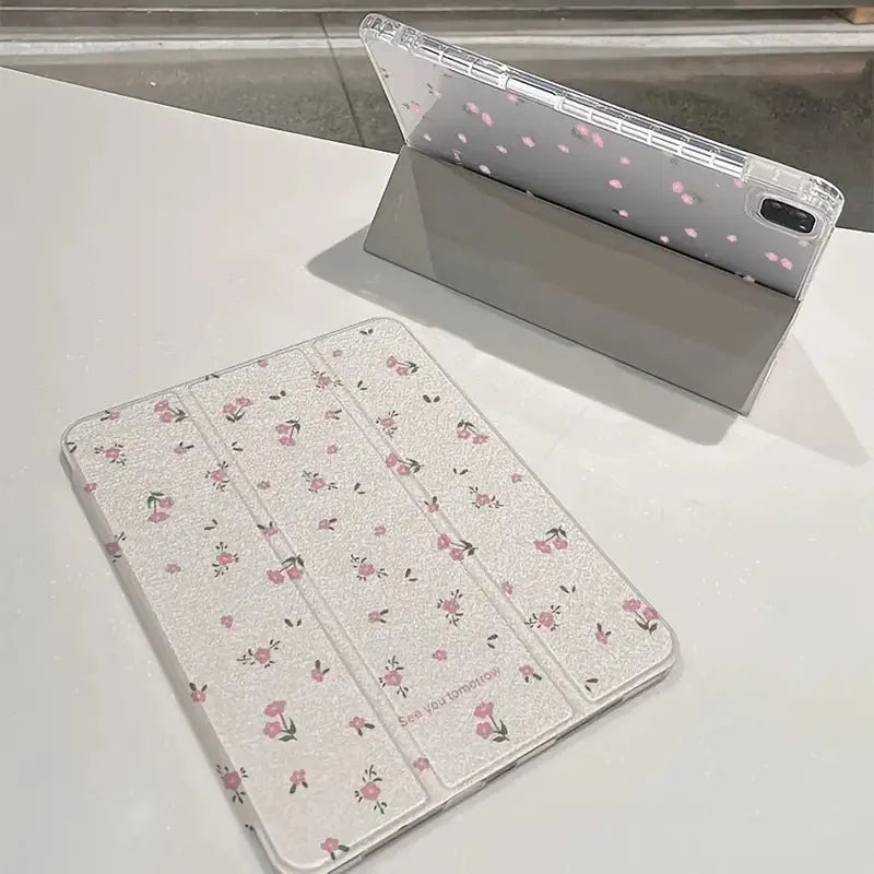 Transparent floral patterned tri-fold hard case for Apple iPad showing stand angle.