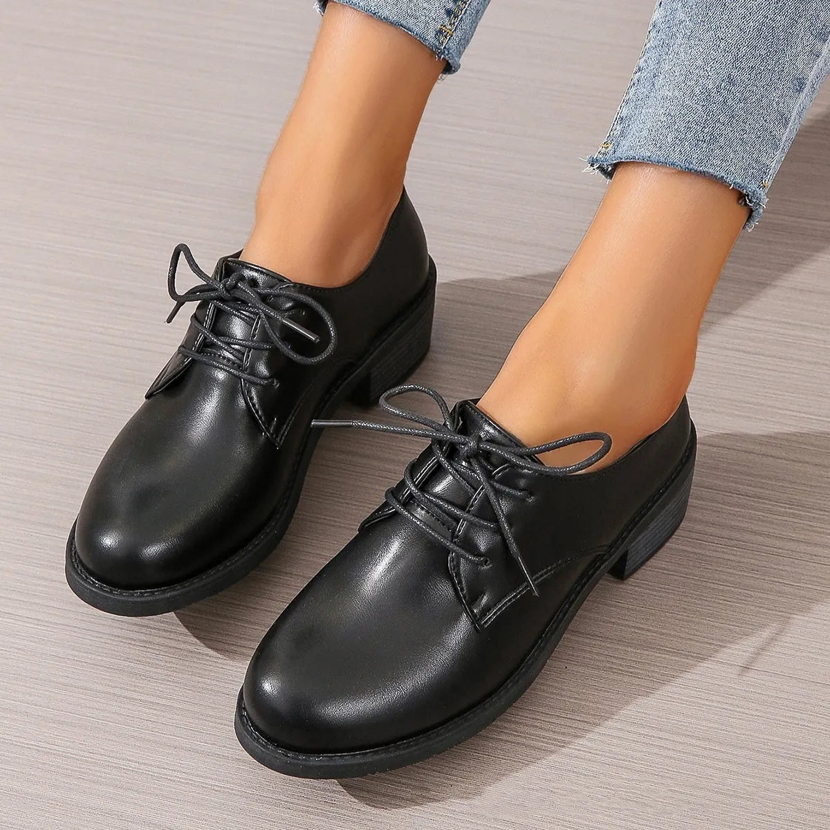 Black women's lace-up work shoes with a thick chunky heel and soft rubber sole.