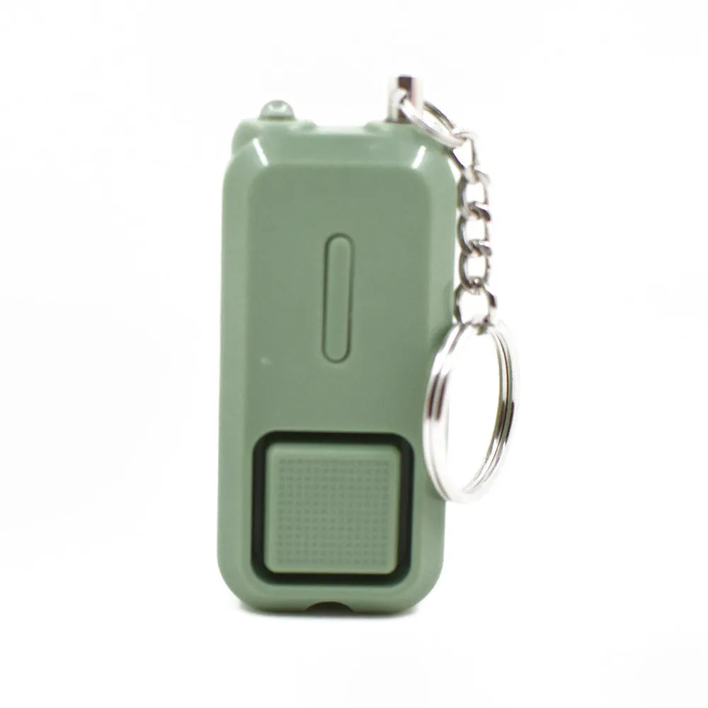 ZQ-202 personal safety alarm in pink, showing compact size next to a ruler for scale.
