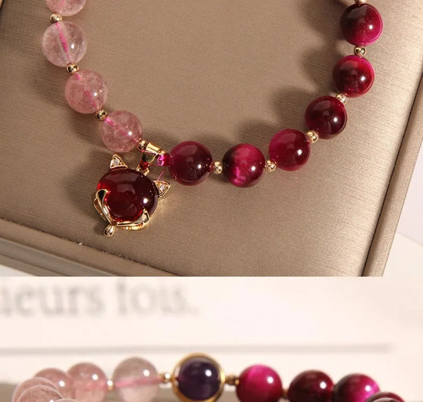 Strawberry crystal bracelet on wrist showing elastic rope construction and natural stone colour