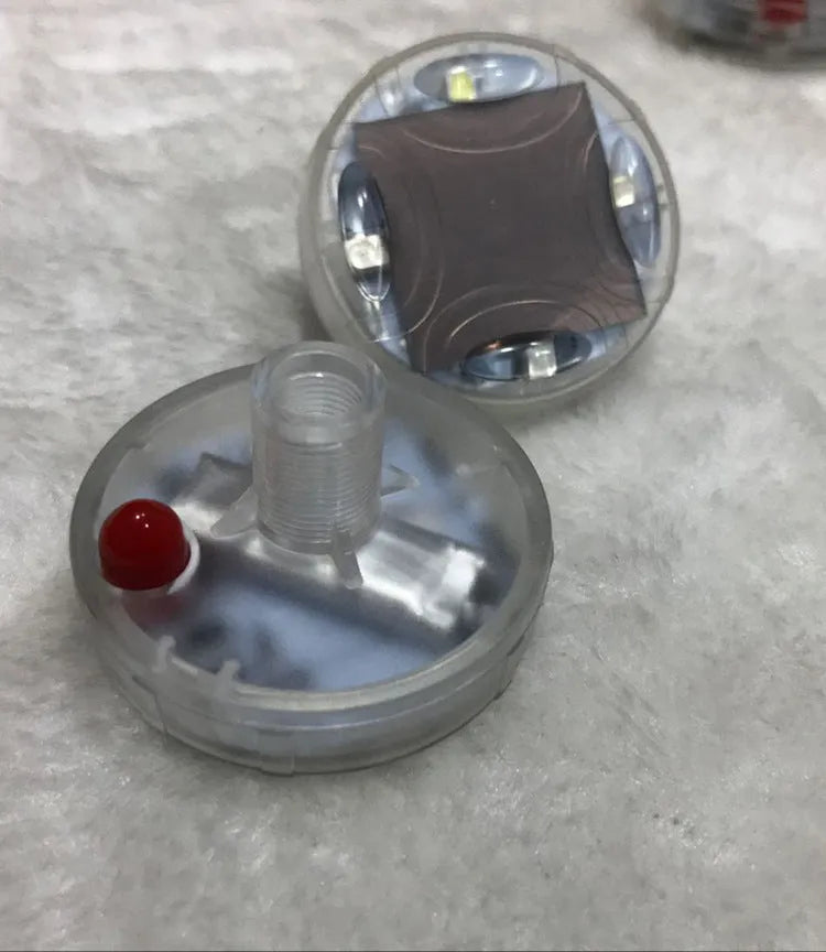 Colourful solar-powered LED valve light for mounting on a vehicle wheel hub.