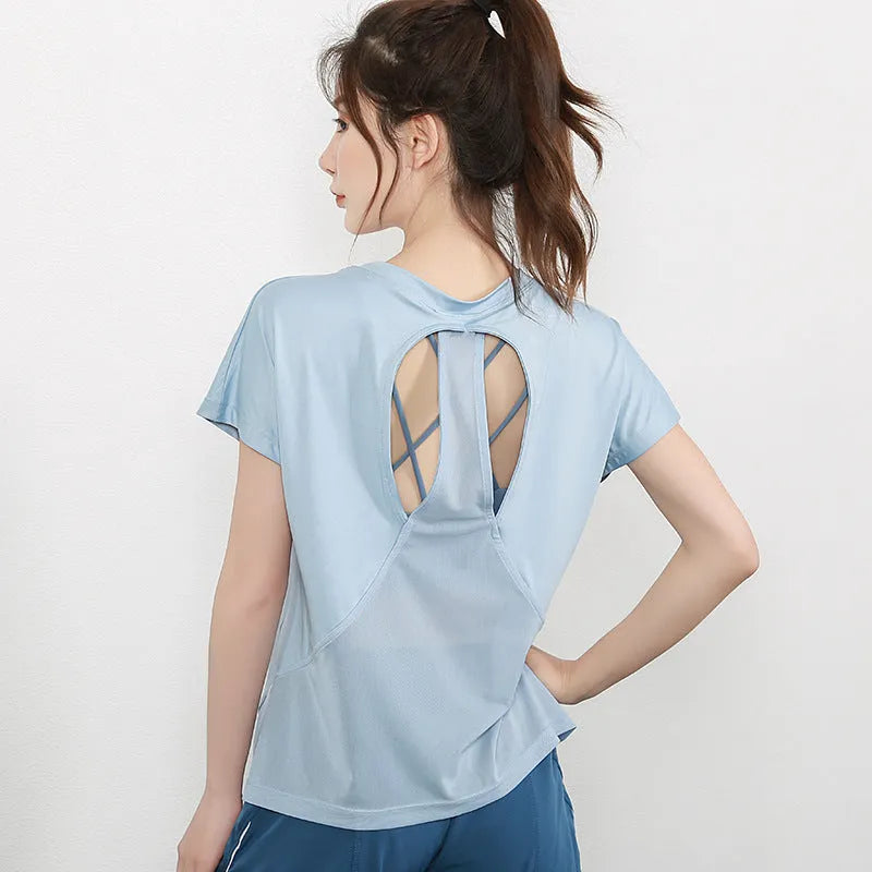 Women's short sleeve polyester sports t-shirt in pink, shown in a casual athletic style.