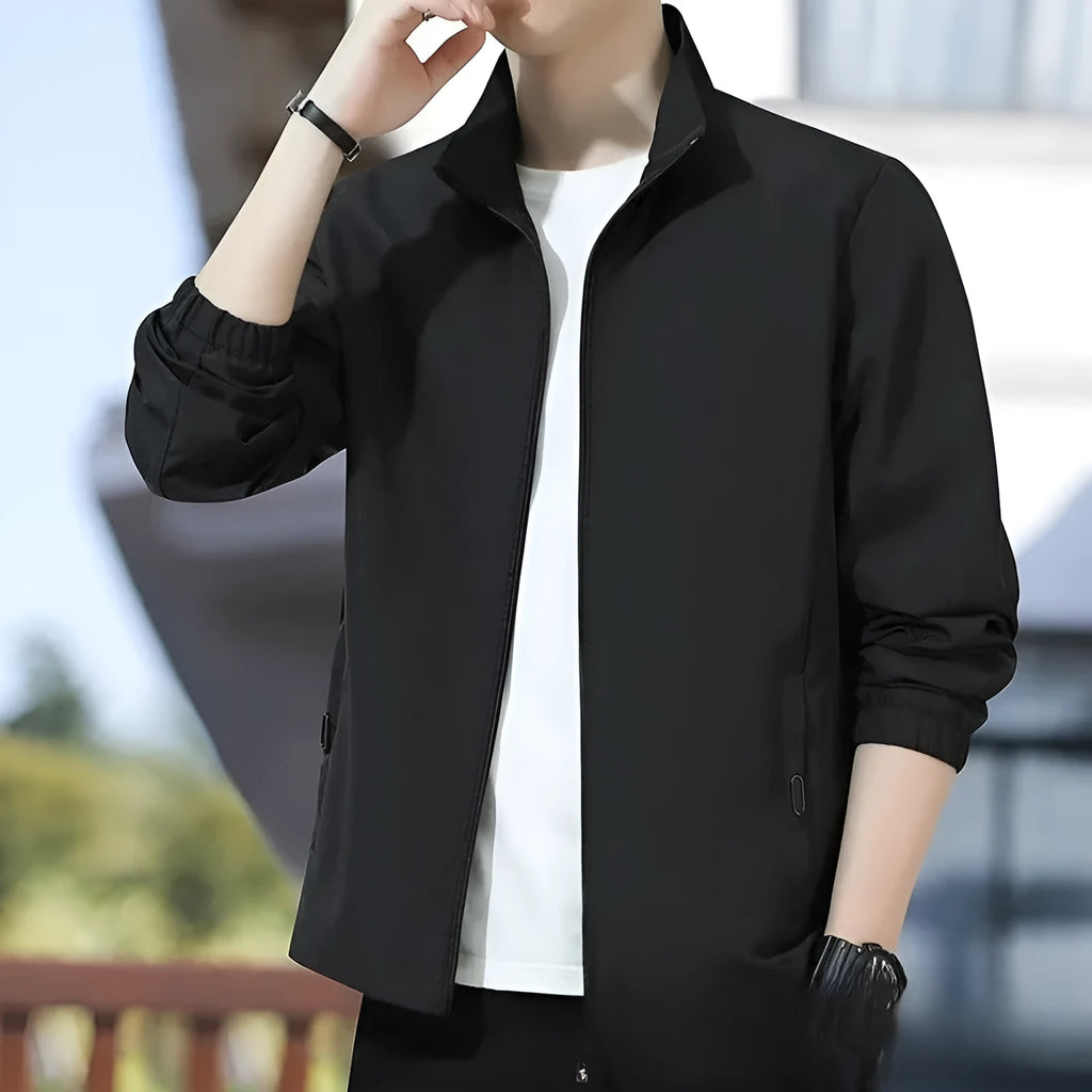 Man wearing a loose-fit Korean-style casual jacket in a dark colour, showing the lapel design, zip, and pockets.