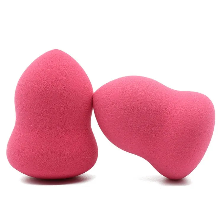 Pink teardrop-shaped makeup blending sponge on a flat surface