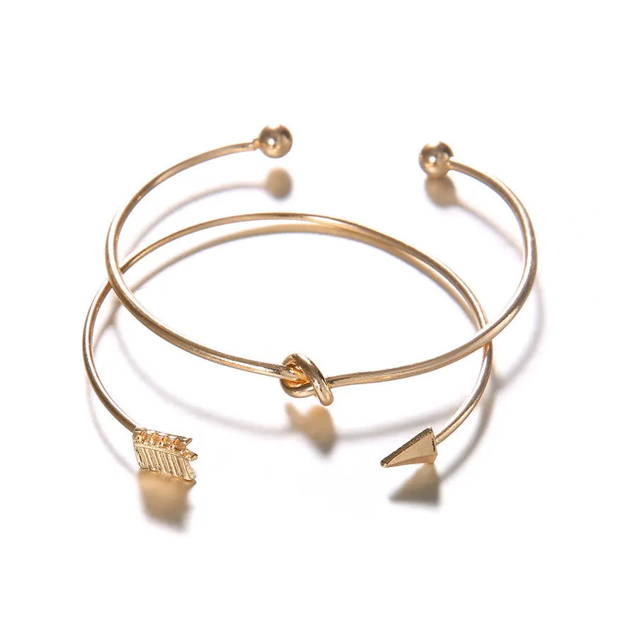 Gold vintage cuff bracelet for women with an arrow knot design detail.