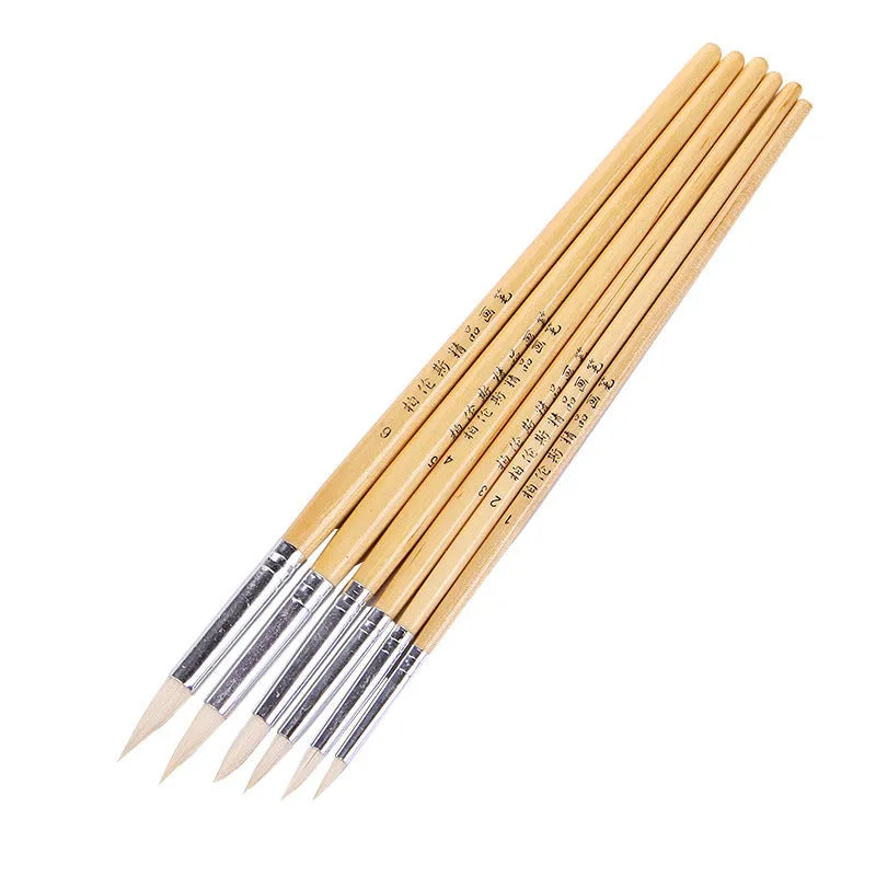 Six wooden hook line pen brushes for drawing and sketching arranged together.