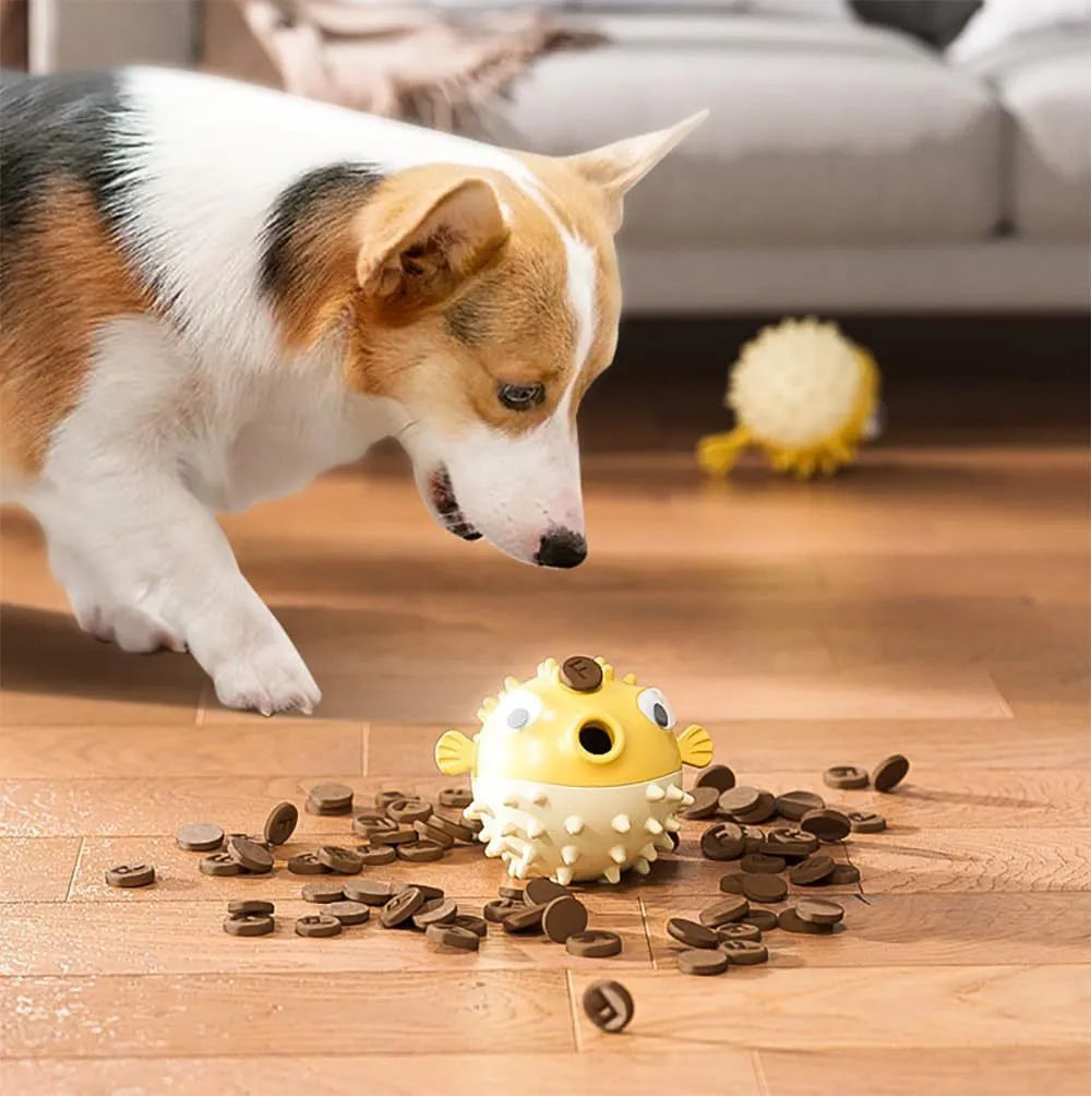 Green fish-shaped interactive dog toy with treat dispensing slots and raised cleaning texture