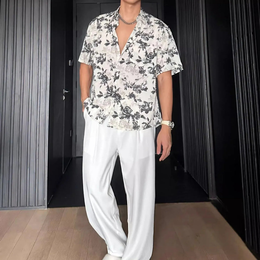 Men's loose black floral print short sleeve casual shirt on a hanger