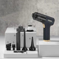 Black wireless car vacuum cleaner with multiple nozzle attachments including inflation nozzle and brush heads