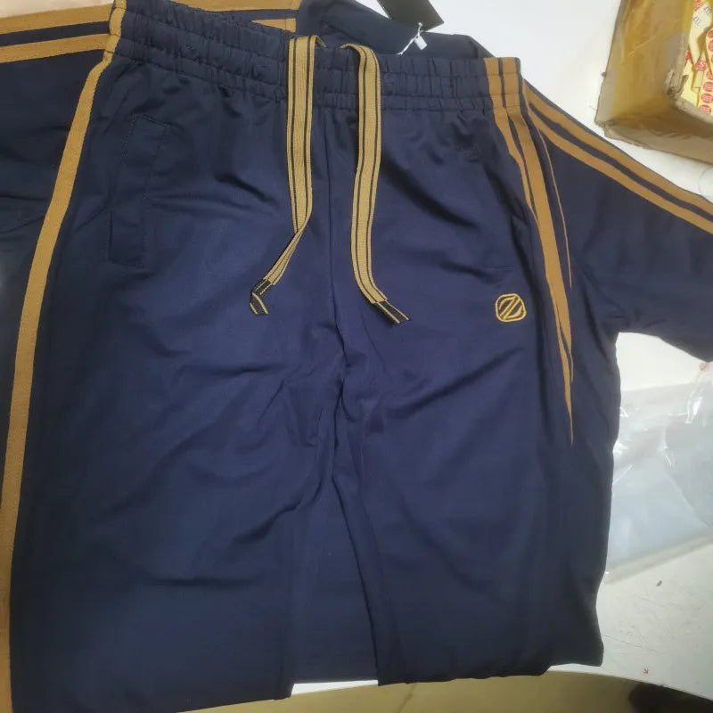 Man wearing a blue short sleeve suit top and pants made from ice silk style polyester fabric.
