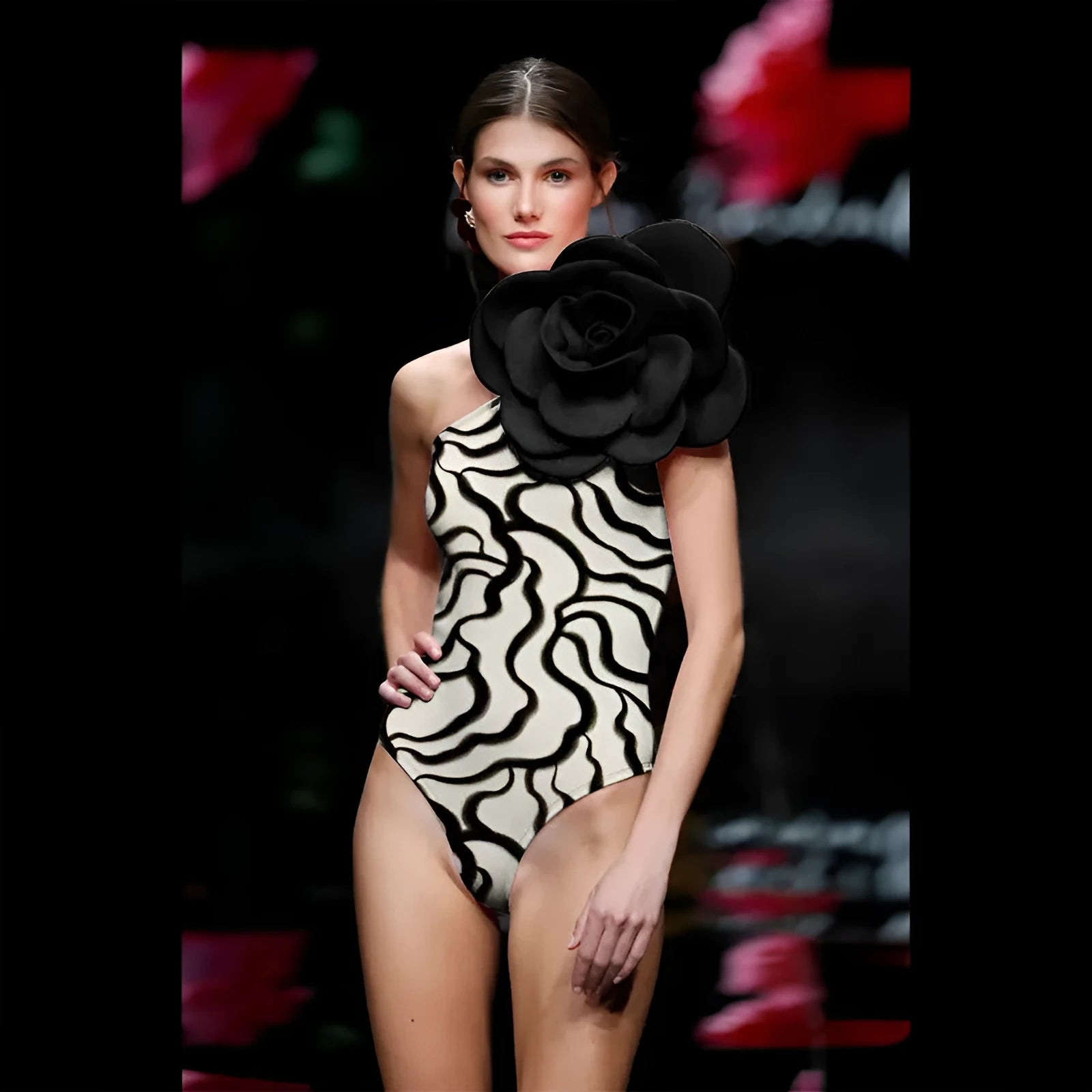 Women's solid colour one-piece swimsuit with three-dimensional flower design.