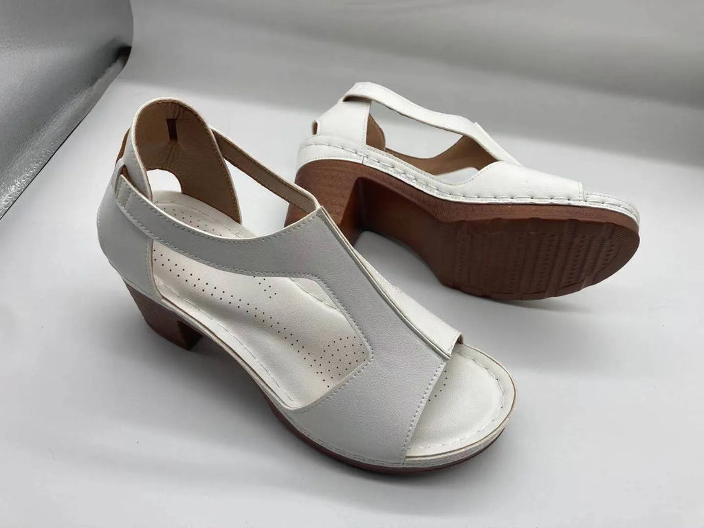 Women's plus size beige peep toe wedge sandals with a buckle strap and low heel.